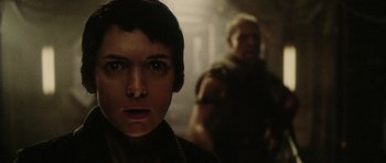 Movie still from “Alien: Resurrection” (1997), directed by Jean-Pierre Jeunet – A man and a woman standing next to each other in a dark room; Close Up shot, Over the shoulder angle