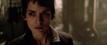 Movie still from “Alien: Resurrection” (1997), directed by Jean-Pierre Jeunet – A person wearing a jacket and staring at the camera; Close Up shot, Low angle