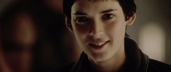 Movie still from “Alien: Resurrection” (1997), directed by Jean-Pierre Jeunet – A person smiling for the camera; Close Up shot, Over the shoulder angle
