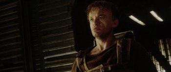 Movie still from “Alien: Resurrection” (1997), directed by Jean-Pierre Jeunet – A person in a room; Close Up shot, Low angle