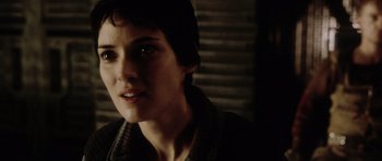 Movie still from “Alien: Resurrection” (1997), directed by Jean-Pierre Jeunet – A young woman is looking into the distance; Close Up shot, Over the shoulder angle