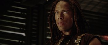 Movie still from “Alien: Resurrection” (1997), directed by Jean-Pierre Jeunet – A person with dreads looking at the camera; Close Up shot, Low angle
