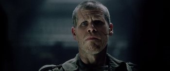 Movie still from “Alien: Resurrection” (1997), directed by Jean-Pierre Jeunet – A person wearing a military uniform; Close Up shot, Low angle