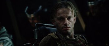 Movie still from “Alien: Resurrection” (1997), directed by Jean-Pierre Jeunet – A person sitting in a chair; Close Up shot, Low angle