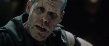 Movie still from “Alien: Resurrection” (1997), directed by Jean-Pierre Jeunet – A person with a face paint; Close Up shot, Over the shoulder angle