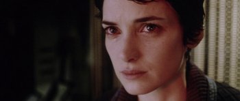 Movie still from “Alien: Resurrection” (1997), directed by Jean-Pierre Jeunet – A woman's face in a dark room; Close Up shot, Low angle