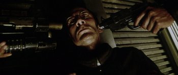 Movie still from “Alien: Resurrection” (1997), directed by Jean-Pierre Jeunet – A person holding a gun; Close Up shot, Low angle