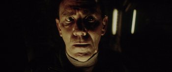 Movie still from “Alien: Resurrection” (1997), directed by Jean-Pierre Jeunet – A person's face in the dark; Close Up shot, Low angle