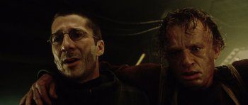 Movie still from “Alien: Resurrection” (1997), directed by Jean-Pierre Jeunet – A man and a woman sitting next to each other in a dark room; Close Up shot, Low angle