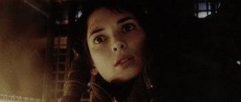 Movie still from “Alien: Resurrection” (1997), directed by Jean-Pierre Jeunet – A young person's face in the dark; Close Up shot, Low angle