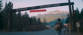 Movie still from “First Blood” (1982), directed by Ted Kotcheff – A sign that says welcome to holidayland; Wide shot, Low angle