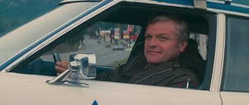 Movie still from “First Blood” (1982), directed by Ted Kotcheff – A man sitting in the driver's seat of a car; Close Up shot, Low angle