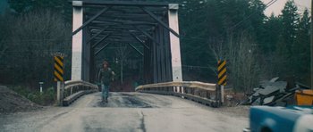 Movie still from “First Blood” (1982), directed by Ted Kotcheff – A man riding a skateboard across a bridge; Wide shot, High angle