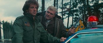 Movie still from “First Blood” (1982), directed by Ted Kotcheff – Two men are looking at something on a tablet; Close Up shot, Over the shoulder angle