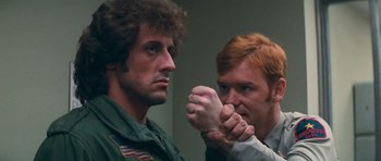 Movie still from “First Blood” (1982), directed by Ted Kotcheff – Two men are fighting in a room; Close Up shot, Over the shoulder angle