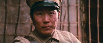 Movie still from “First Blood” (1982), directed by Ted Kotcheff – A man wearing a uniform and a hat; Close Up shot, Low angle