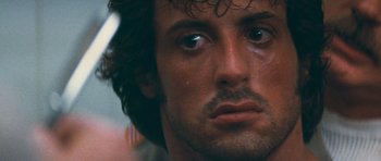 Movie still from “First Blood” (1982), directed by Ted Kotcheff – Sylvester stallone's face with tears in his eyes; Extreme Close Up shot, Low angle
