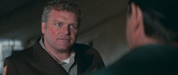 Movie still from “First Blood” (1982), directed by Ted Kotcheff – A person wearing a brown jacket; Close Up shot, Over the shoulder angle