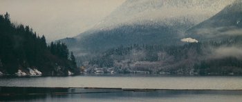 Movie still from “First Blood” (1982), directed by Ted Kotcheff – A body of water surrounded by snow covered trees; Extreme Wide shot, High angle