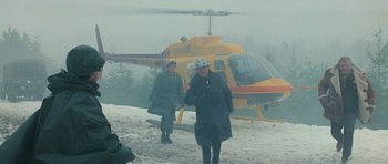 Movie still from “First Blood” (1982), directed by Ted Kotcheff – Two people walking in the snow next to a yellow helicopter; Wide shot, High angle