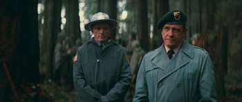 Movie still from “First Blood” (1982), directed by Ted Kotcheff – Two men standing next to each other in the woods; Medium shot, Low angle