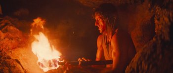 Movie still from “First Blood” (1982), directed by Ted Kotcheff – A man is sitting in front of a fire; Close Up shot, Low angle