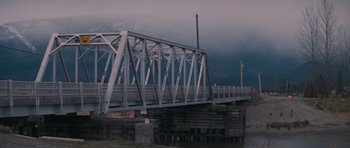 Movie still from “First Blood” (1982), directed by Ted Kotcheff – A bridge with a cloudy sky in the background; Extreme Wide shot, Low angle