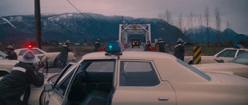 Movie still from “First Blood” (1982), directed by Ted Kotcheff – A car is driving on a bridge over a river; Extreme Wide shot, High angle