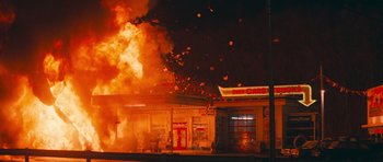 Movie still from “First Blood” (1982), directed by Ted Kotcheff – A building on fire in a city at night; Extreme Wide shot, High angle