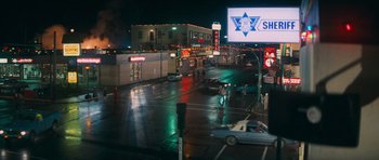 Movie still from “First Blood” (1982), directed by Ted Kotcheff – A view of an intersection at night in the rain; Extreme Wide shot, High angle
