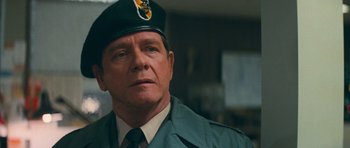 Movie still from “First Blood” (1982), directed by Ted Kotcheff – A person wearing a uniform; Close Up shot, Over the shoulder angle