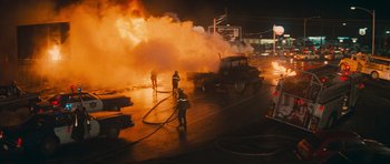 Movie still from “First Blood” (1982), directed by Ted Kotcheff – A group of people that are standing next to a fire truck; Extreme Wide shot, High angle