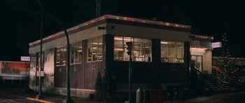 Movie still from “First Blood” (1982), directed by Ted Kotcheff – A building that has a traffic light in front of it at night; Extreme Wide shot, Low angle