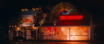 Movie still from “First Blood” (1982), directed by Ted Kotcheff – The outside of a restaurant at night time; Extreme Wide shot, Low angle