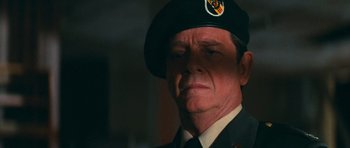 Movie still from “First Blood” (1982), directed by Ted Kotcheff – An older man wearing a hat and a uniform; Close Up shot, Over the shoulder angle