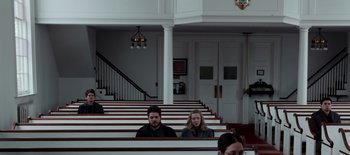 Movie still from “First Reformed” (2017), directed by Paul Schrader – A man and a woman sitting in a church pew; Wide shot, High angle