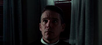 Movie still from “First Reformed” (2017), directed by Paul Schrader – A person looking at the camera; Close Up shot, Low angle