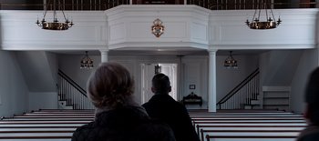 Movie still from “First Reformed” (2017), directed by Paul Schrader – A man and a woman standing in front of an open door in a church; Wide shot, Low angle