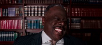 Movie still from “First Reformed” (2017), directed by Paul Schrader – A person wearing a suit and tie; Close Up shot, Low angle