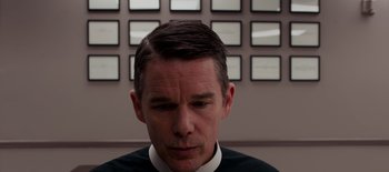 Movie still from “First Reformed” (2017), directed by Paul Schrader – A person wearing a black and white shirt; Close Up shot, Low angle