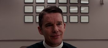 Movie still from “First Reformed” (2017), directed by Paul Schrader – A person wearing a clerical collar; Close Up shot, Over the shoulder angle