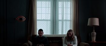 Movie still from “First Reformed” (2017), directed by Paul Schrader – A man and a woman sitting next to each other on a couch; Medium shot, Low angle