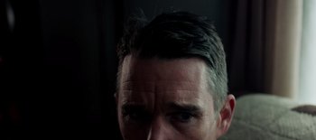 Movie still from “First Reformed” (2017), directed by Paul Schrader – A man's head with a black background; Extreme Close Up shot, Low angle