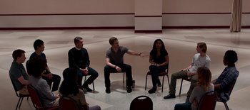 Movie still from “First Reformed” (2017), directed by Paul Schrader – A group of people sitting in a circle talking to each other; Wide shot, High angle