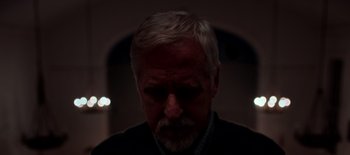 Movie still from “First Reformed” (2017), directed by Paul Schrader – An older man's face in the dark; Close Up shot, Low angle