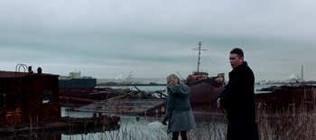 Movie still from “First Reformed” (2017), directed by Paul Schrader – A woman standing in front of an abandoned ship; Extreme Wide shot, Over the shoulder angle