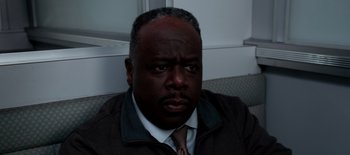 Movie still from “First Reformed” (2017), directed by Paul Schrader – A person wearing a jacket and tie; Close Up shot, High angle