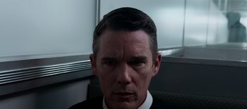 Movie still from “First Reformed” (2017), directed by Paul Schrader – A person wearing a suit and tie; Close Up shot, Low angle