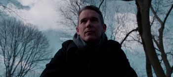 Movie still from “First Reformed” (2017), directed by Paul Schrader – A person wearing a black jacket; Close Up shot, Low angle