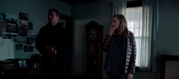 Movie still from “First Reformed” (2017), directed by Paul Schrader – Two people standing in a living room next to each other; Medium shot, Low angle